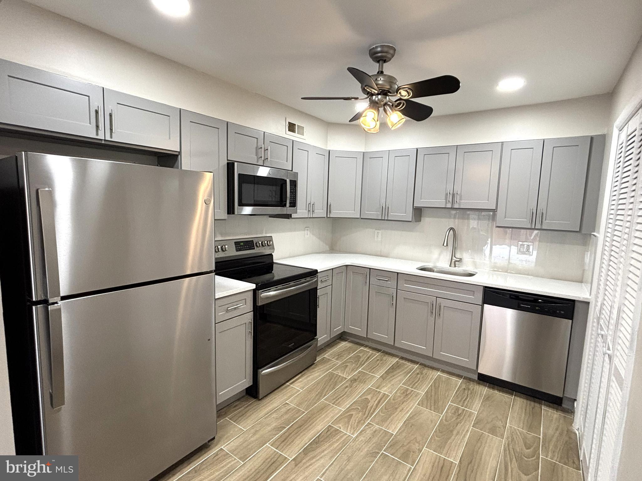 104 Chaucer Road, Unit A Mount Laurel, NJ 08054 - Photo 9 of 20 a kitchen with stainless steel appliances granite countertop a refrigerator a sink a stove a microwave oven a sink and dishwasher