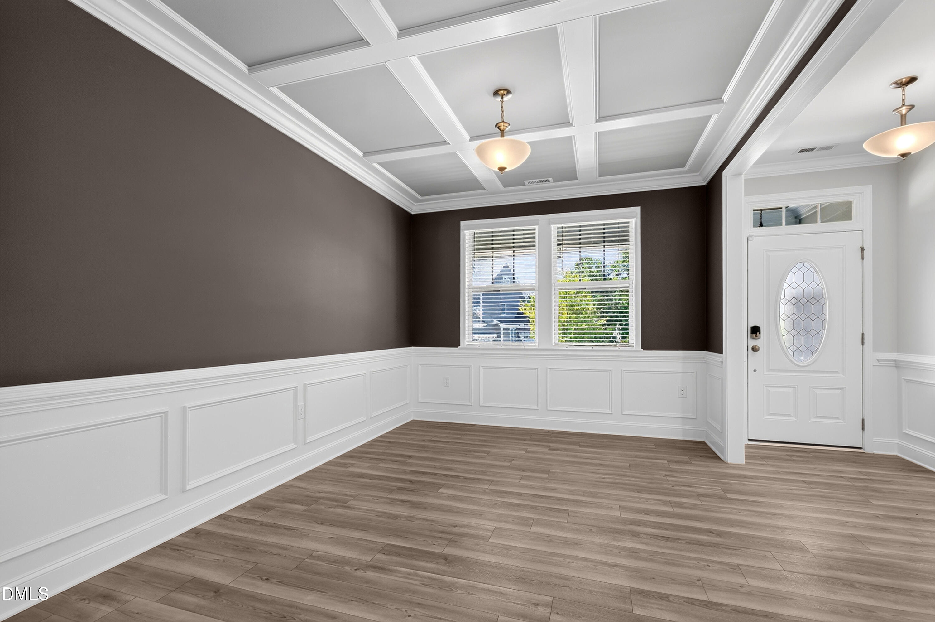 1300 Commons Ford Place Apex, NC 27539 - Photo 8 of 70 a view of an empty room with wooden floor and a window