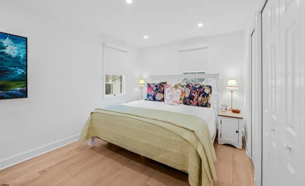 a spacious bedroom with a bed and a window