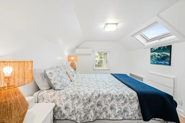 a bedroom with a bed and a painting on the wall