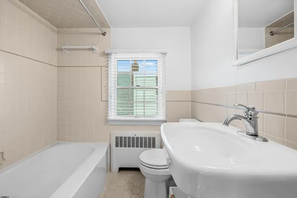 a bathroom with a sink toilet and bathtub