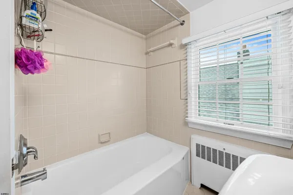 a bathroom with a bathtub and shower