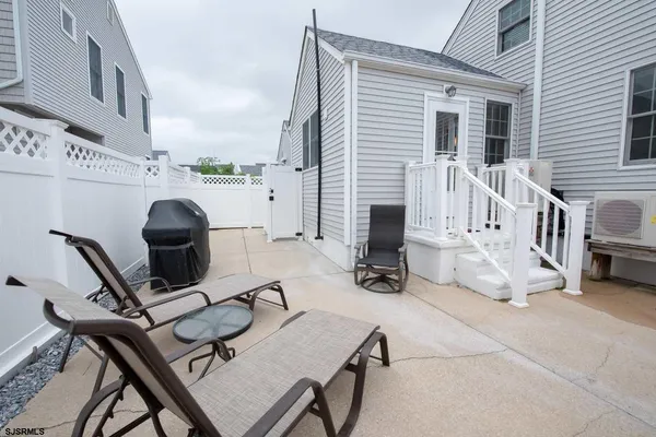 a view of a patio with a table and chairs