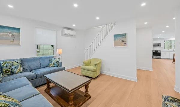 a living room with furniture and a wooden floor
