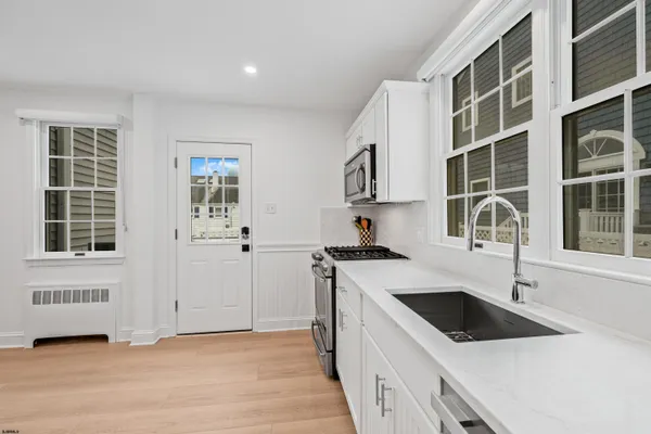 a kitchen with a sink and a stove top oven