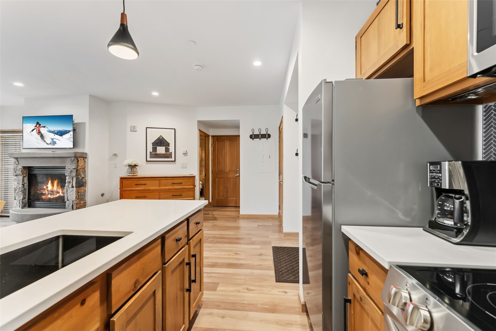195 River Run Road, Unit 8015 Keystone, CO 80435 - Photo 14 of 35 a kitchen with stainless steel appliances granite countertop a refrigerator a stove and a sink with wooden floor