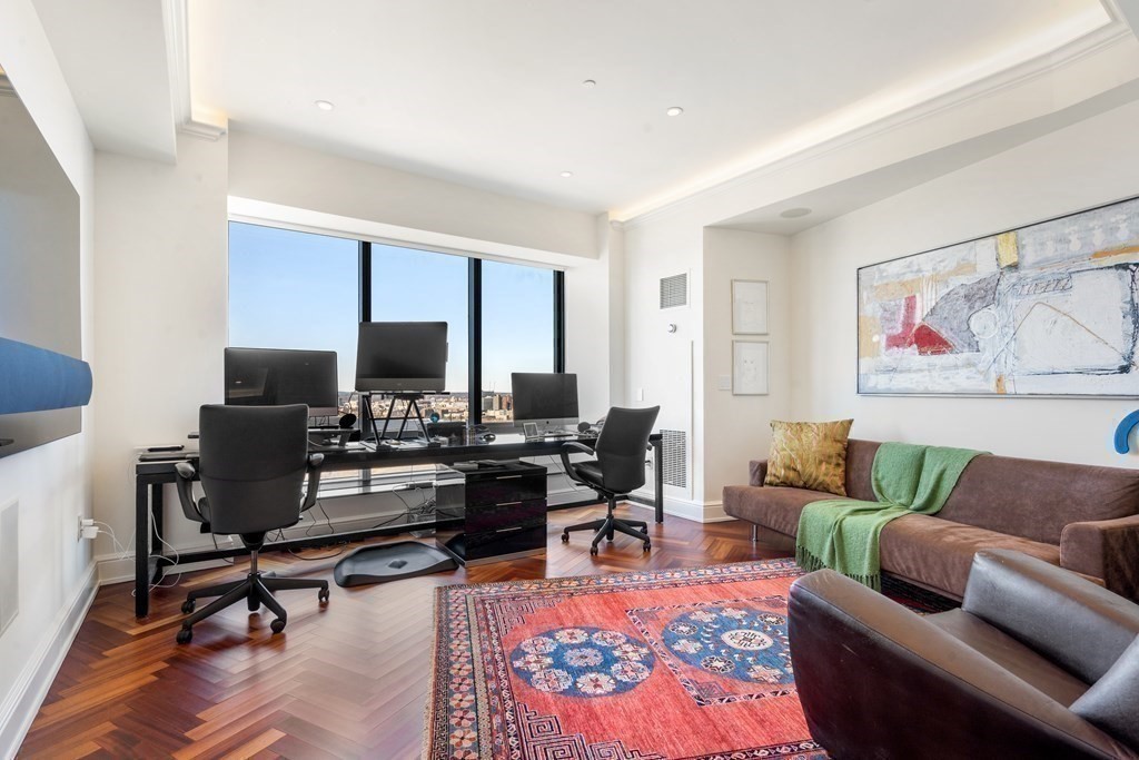 2 Avery Street, Unit 30EF Boston, MA 02111 - Photo 14 of 35 a living room with furniture a rug and a flat screen tv