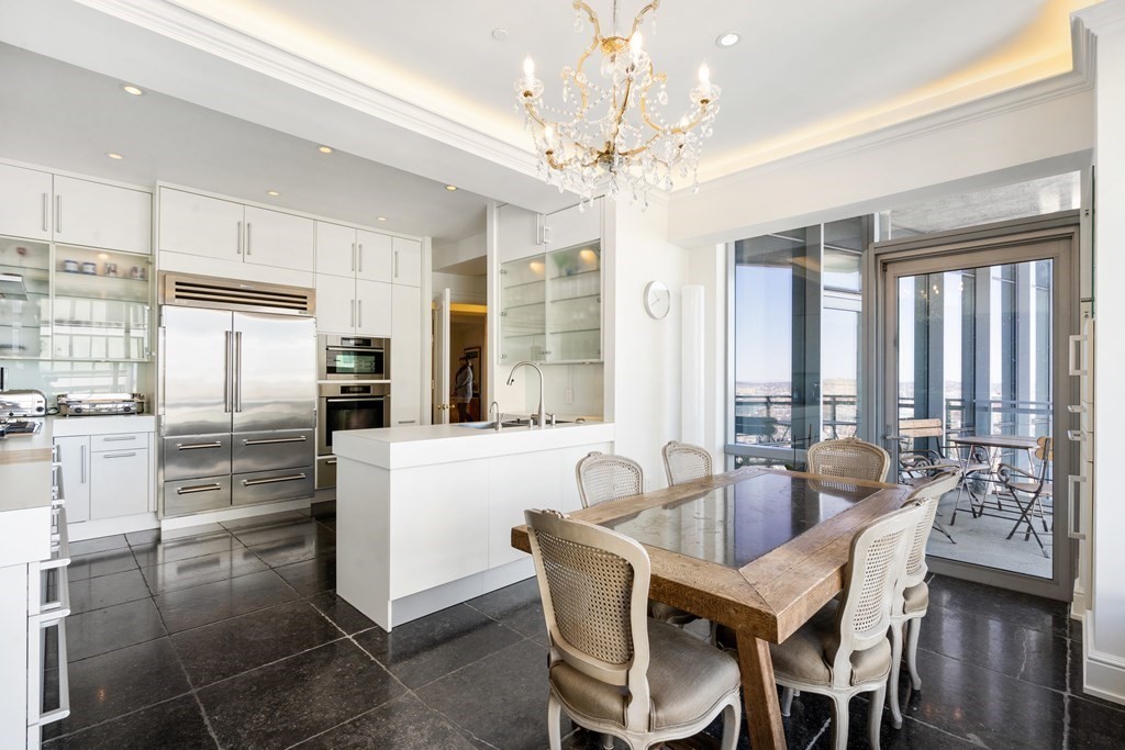 2 Avery Street, Unit 30EF Boston, MA 02111 - Photo 9 of 35 a dining room with furniture a chandelier and kitchen view