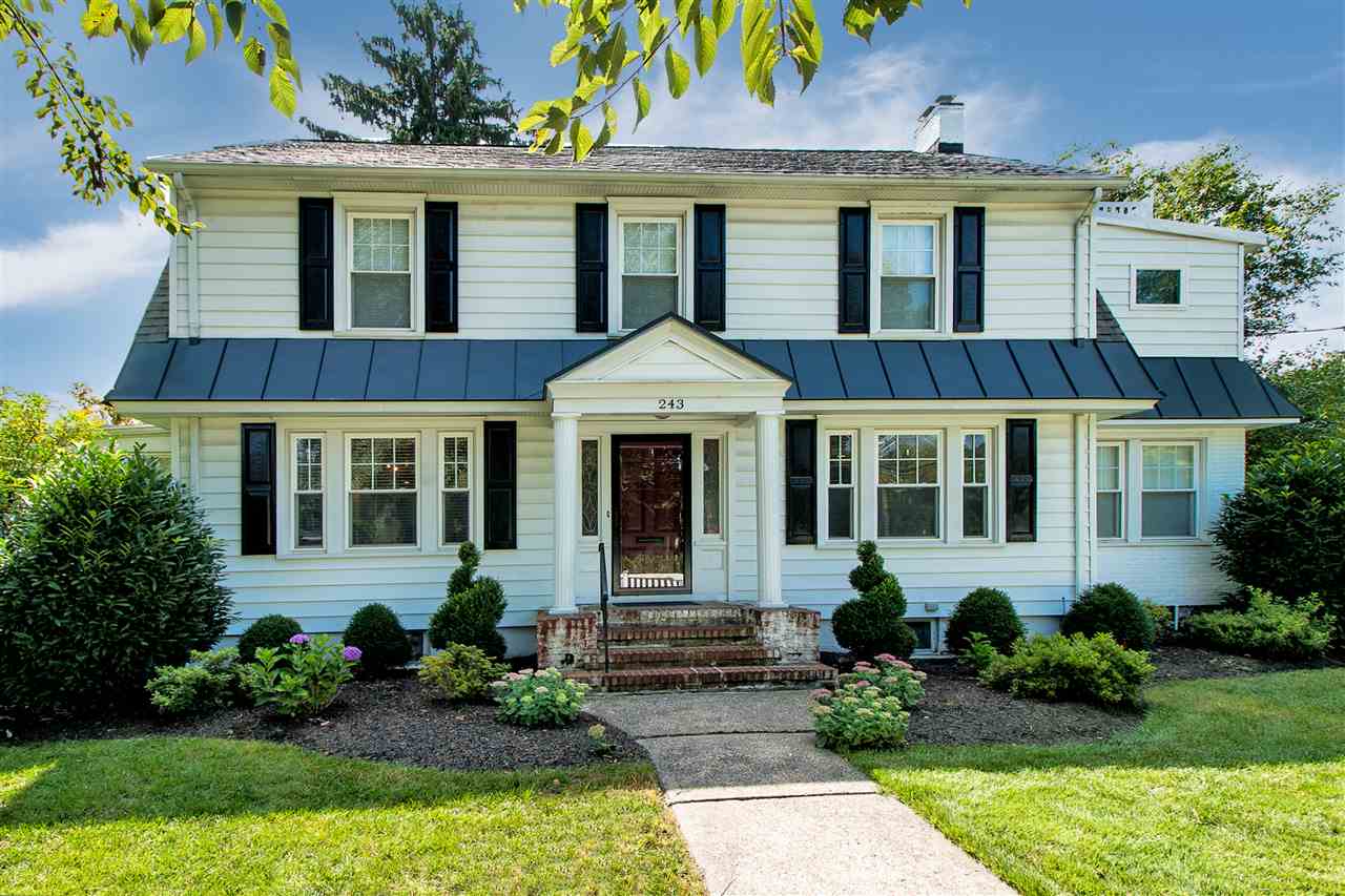 front view of a brick house with a yard