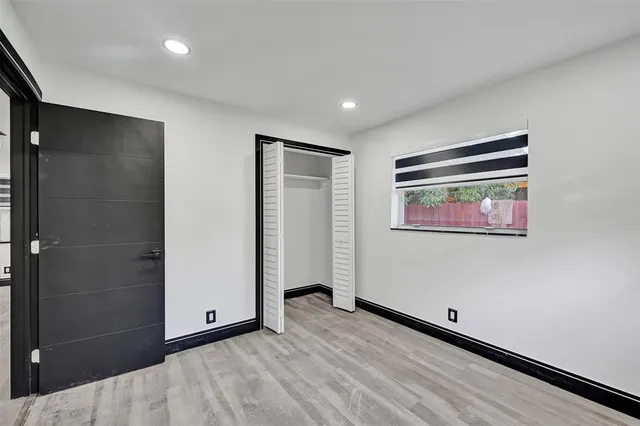 a view of an empty room with a painting on the wall