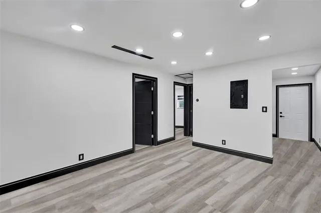 a view of empty room with wooden floor