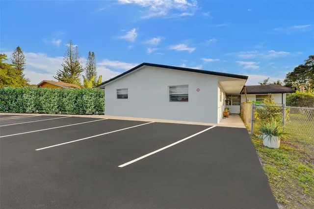 a backyard of a house with table and chairs