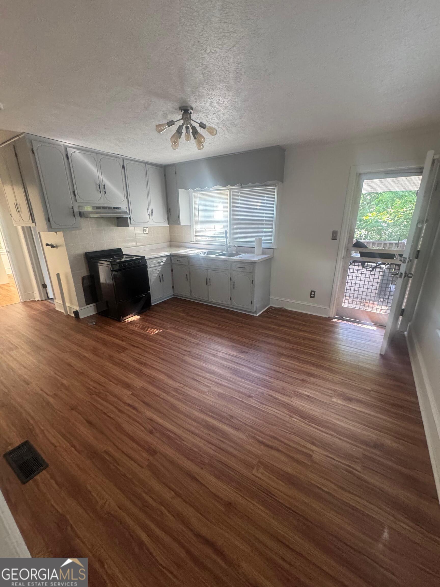 609 West Main Street Thomaston, GA 30286 - Photo 12 of 27 a view of kitchen and kitchen with furniture wooden floor and window
