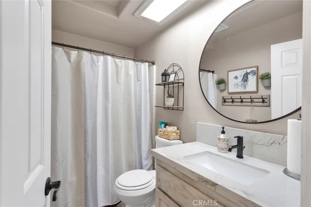 a kitchen with cabinets stainless steel appliances a sink and wooden floor