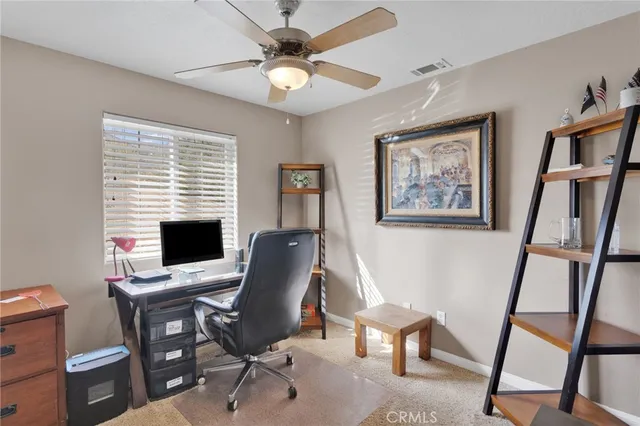 a view of a dining room with a table and chairs
