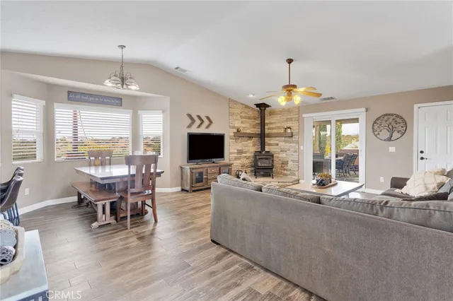 a living room with furniture kitchen view and a flat screen tv