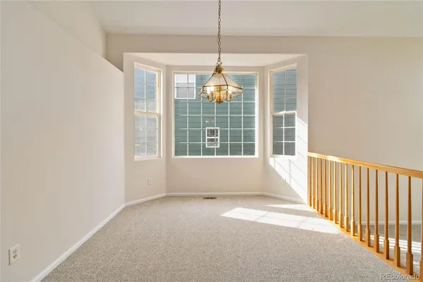 a view of a room with windows and stairs
