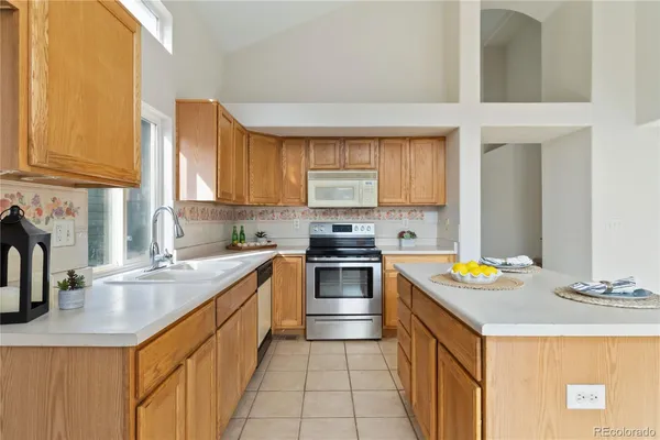 a kitchen with a sink stove top oven and microwave