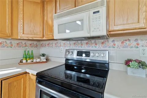 a kitchen with stainless steel appliances granite countertop a stove and a microwave