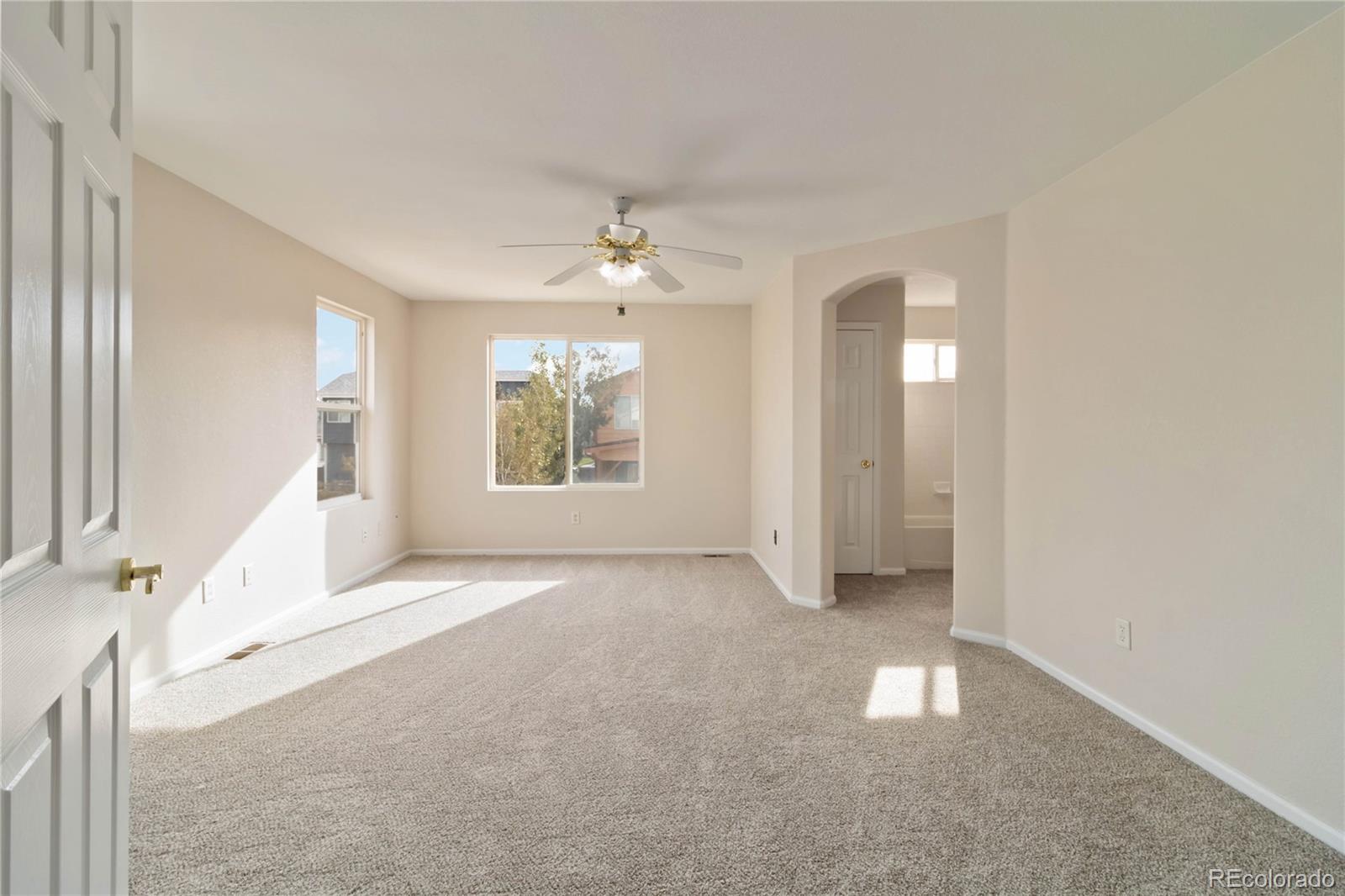 5124 Enid Way Denver, CO 80239 - Photo 24 of 47 an empty room with windows and entrance