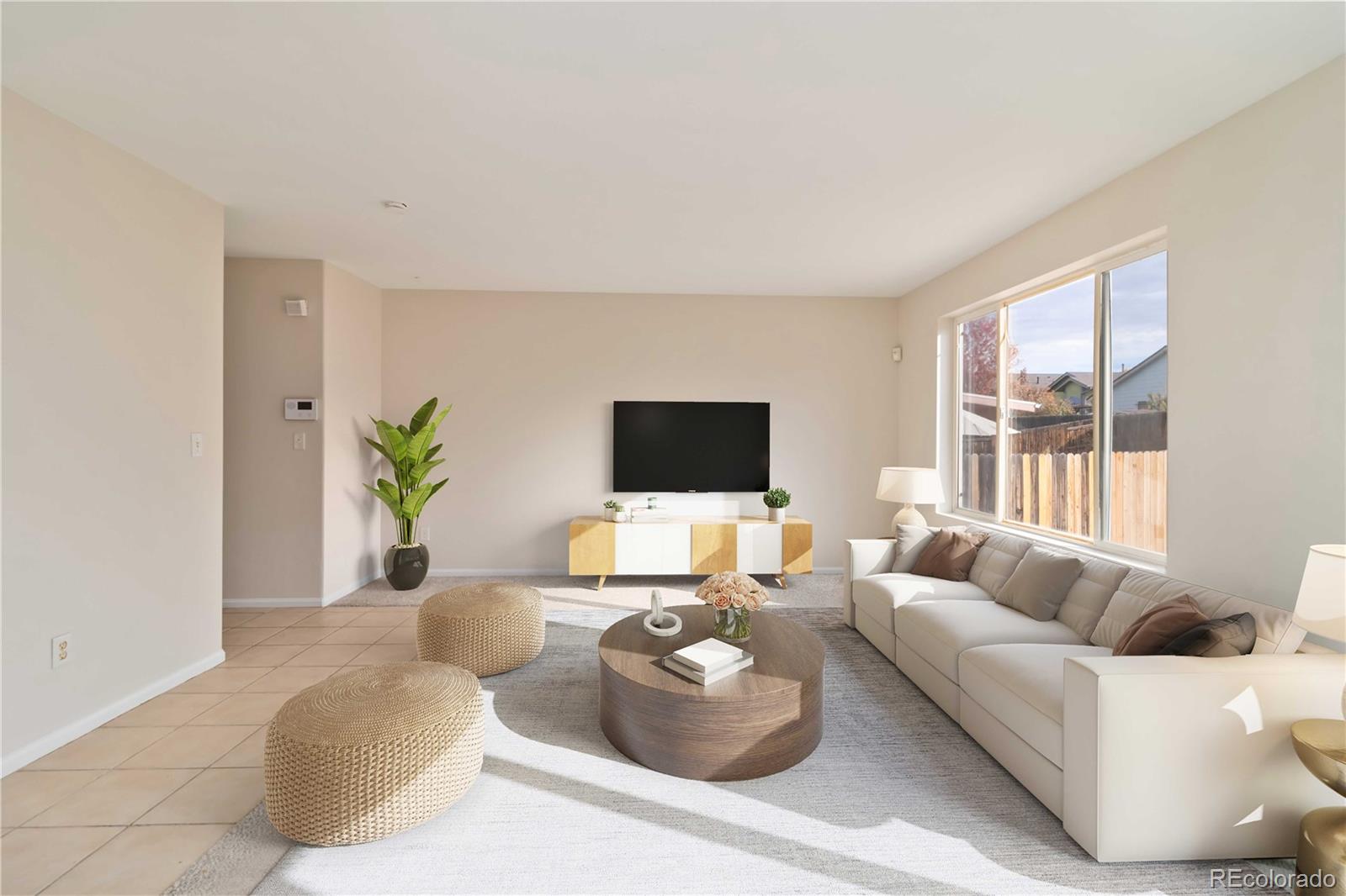 5124 Enid Way Denver, CO 80239 - Photo 24 of 47 a living room with furniture and a flat screen tv