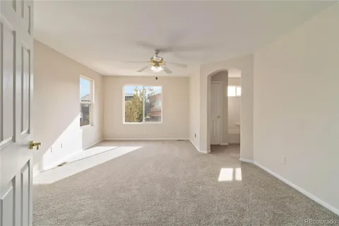 a living room with furniture and large windows
