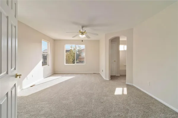 a living room with furniture and large windows