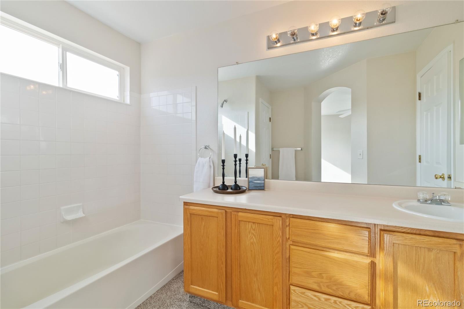 5124 Enid Way Denver, CO 80239 - Photo 29 of 47 a bathroom with a sink and a mirror
