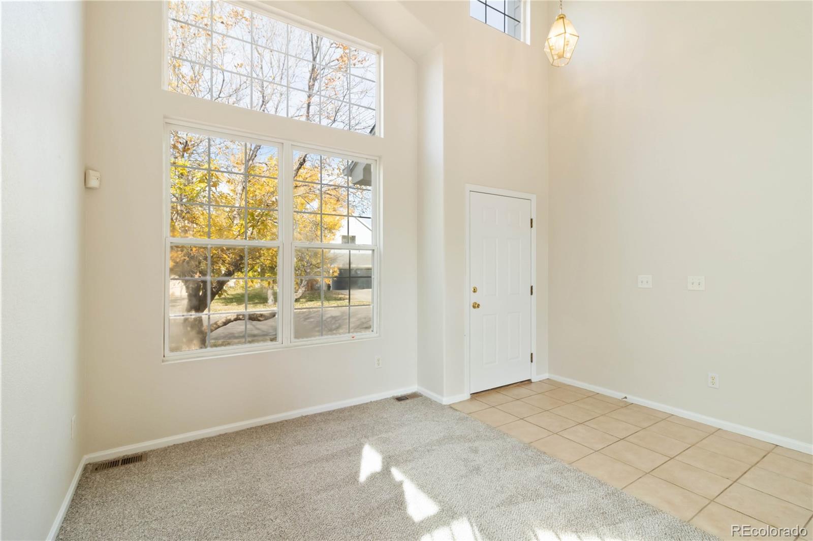 5124 Enid Way Denver, CO 80239 - Photo 3 of 47 an empty room with windows