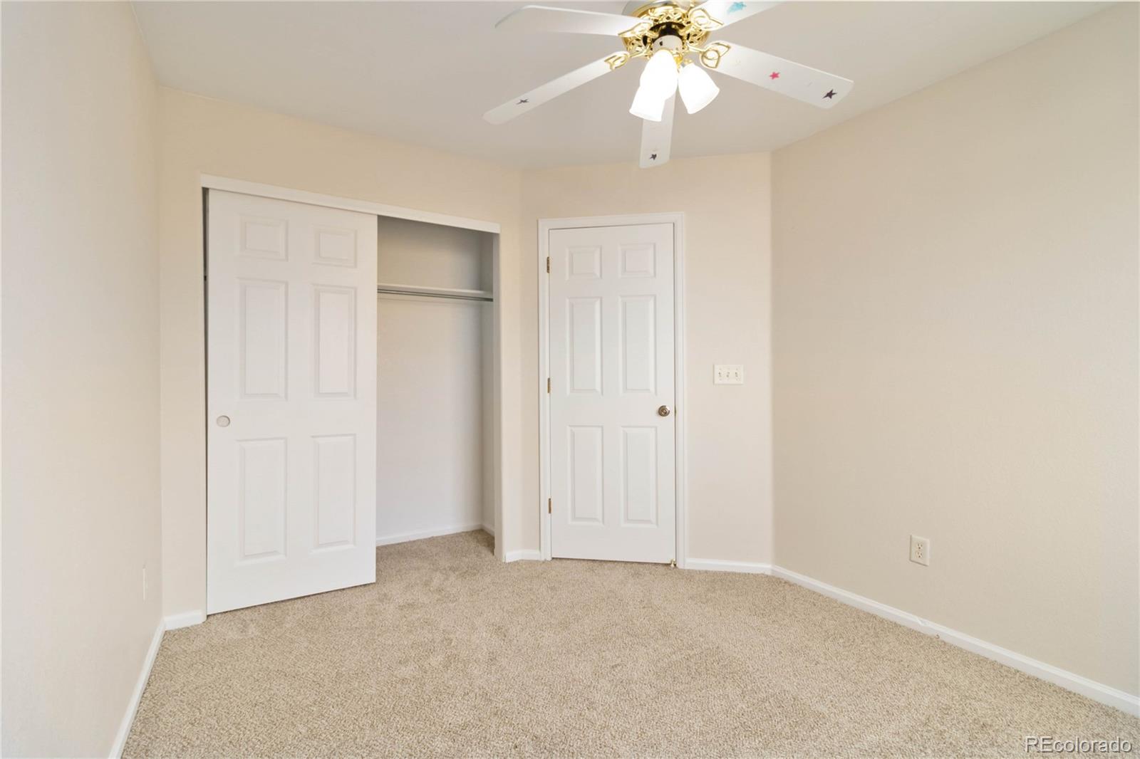 5124 Enid Way Denver, CO 80239 - Photo 32 of 47 an empty room with a ceiling fan and a window