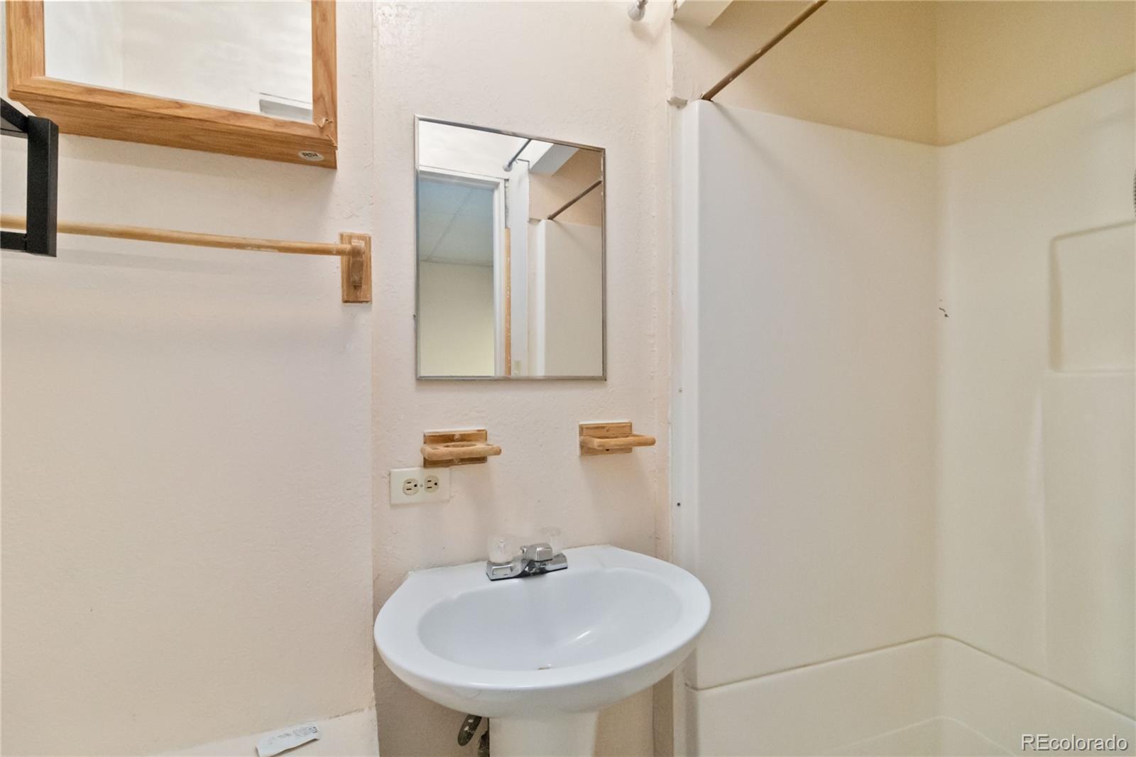 5124 Enid Way Denver, CO 80239 - Photo 39 of 47 a bathroom with a sink and a mirror