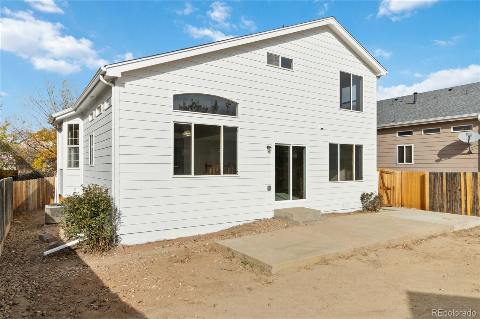 5124 Enid Way Denver, CO 80239 - Photo 43 of 47 a view of a white house with large windows