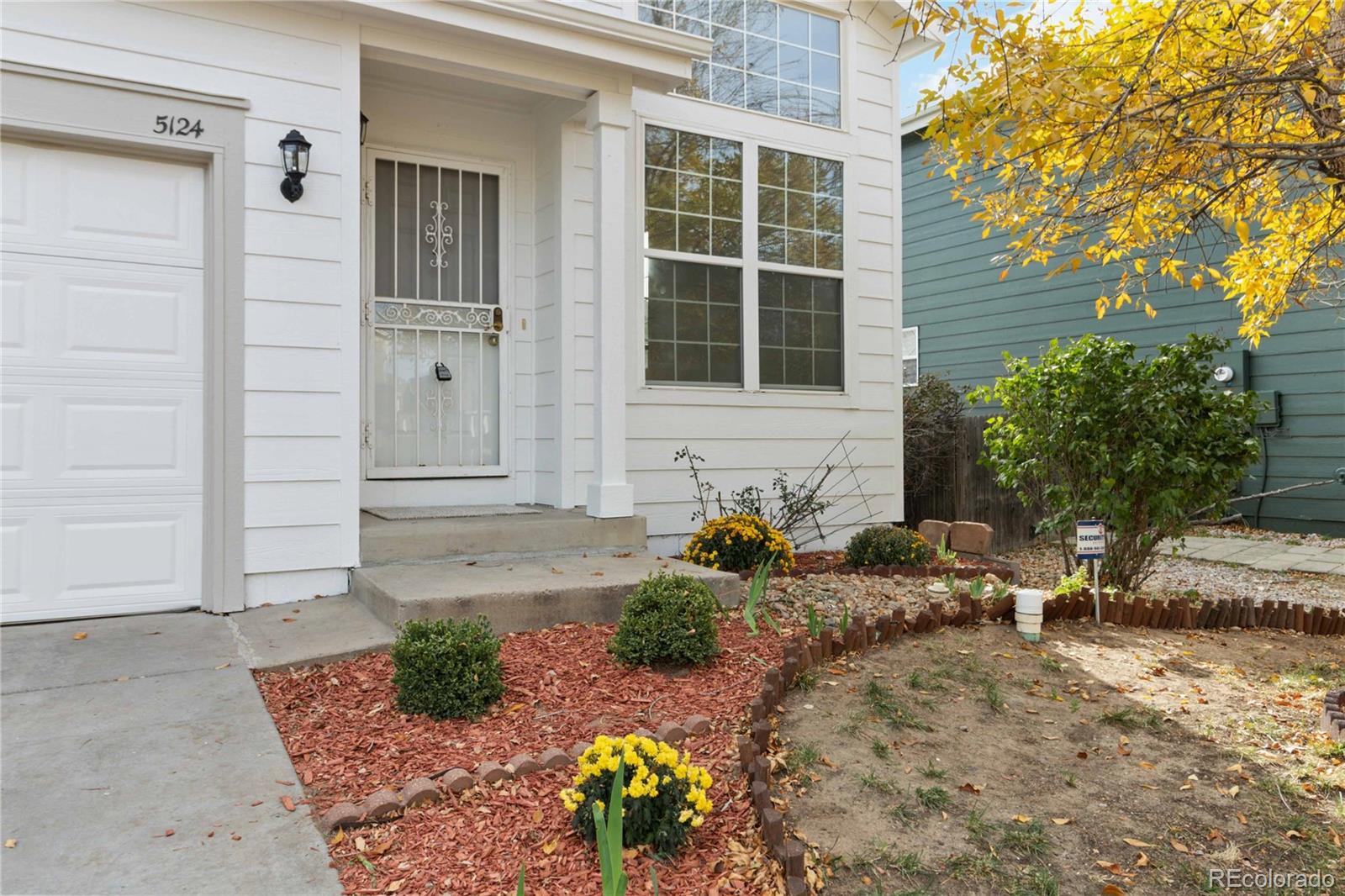5124 Enid Way Denver, CO 80239 - Photo 43 of 47 a front view of a house with a yard