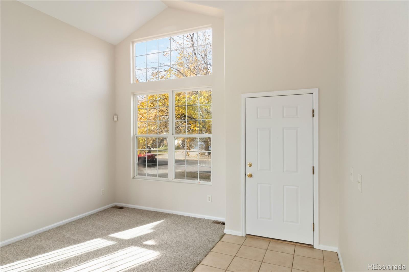 5124 Enid Way Denver, CO 80239 - Photo 5 of 47 an empty room with windows