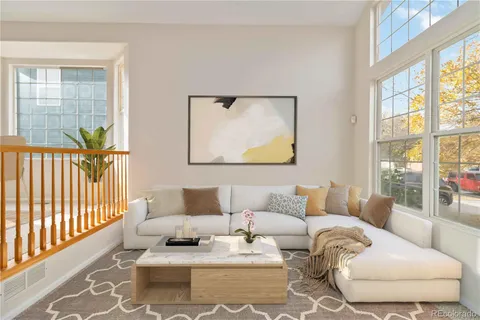 a living room with furniture and a window with outer view