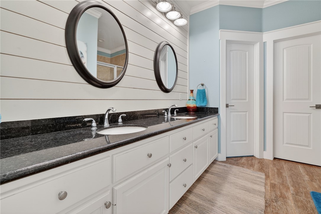 838 Rattlesnake Point Road Rockport, TX 78382 - Photo 23 of 40 a bathroom with a granite countertop double vanity sink and a mirror