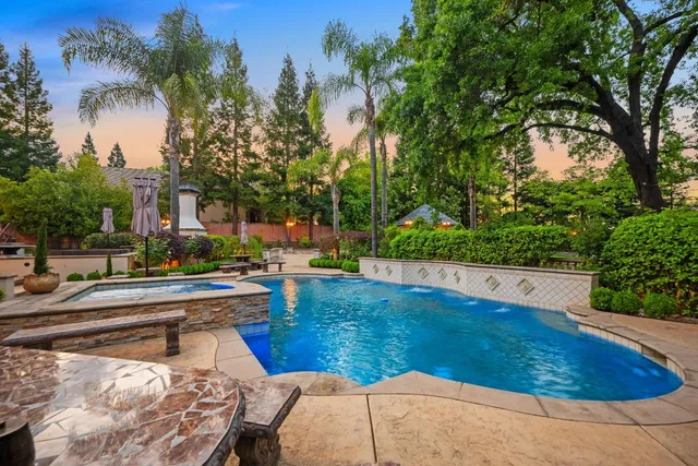 a view of a patio with table and chairs under an umbrella