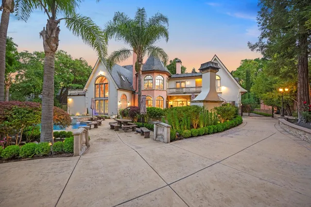 a front view of a house with a garden