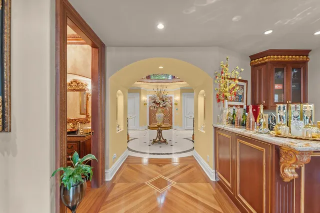 a spacious bedroom with a bed and a chandelier