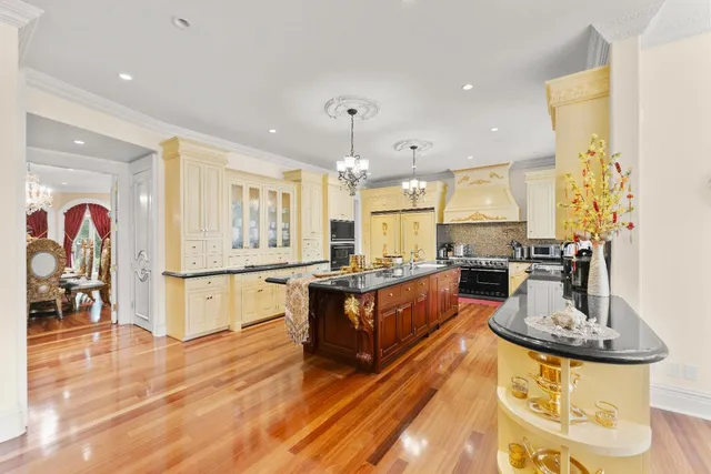 a large white kitchen with a large window