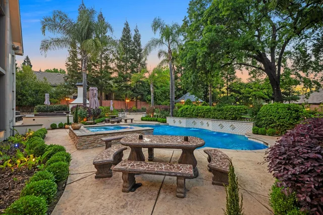 a front view of a house with a yard and potted plants