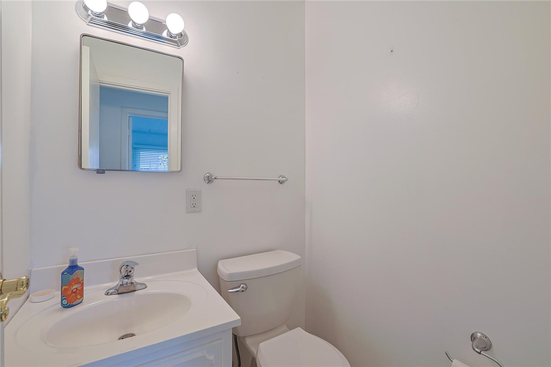 4307 Meadowcroft Road Dayton, OH 45429 - Photo 21 of 26 This bright bathroom features a vanity, mirror, and toilet, offering essential functionality.