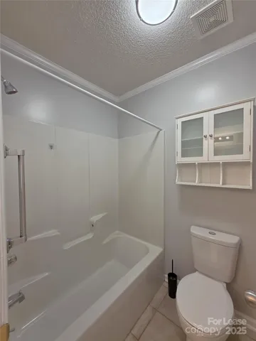 a white toilet and tub next to a bathroom sink