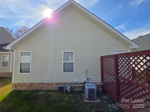 a view of a house with a big yard and large tree