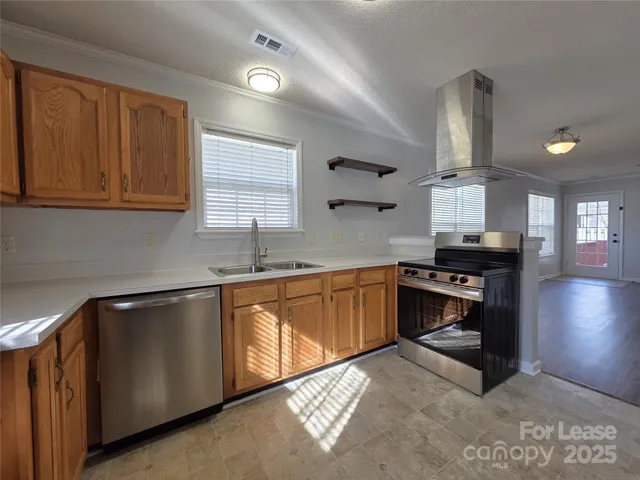 a kitchen with granite countertop a stove and a sink