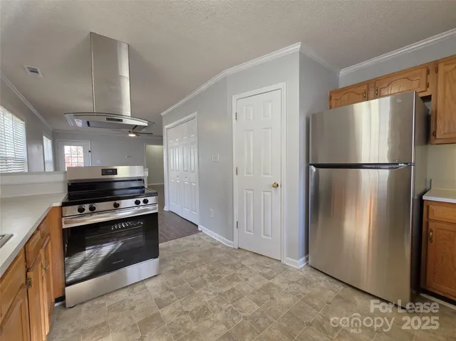 a kitchen with a refrigerator and a stove