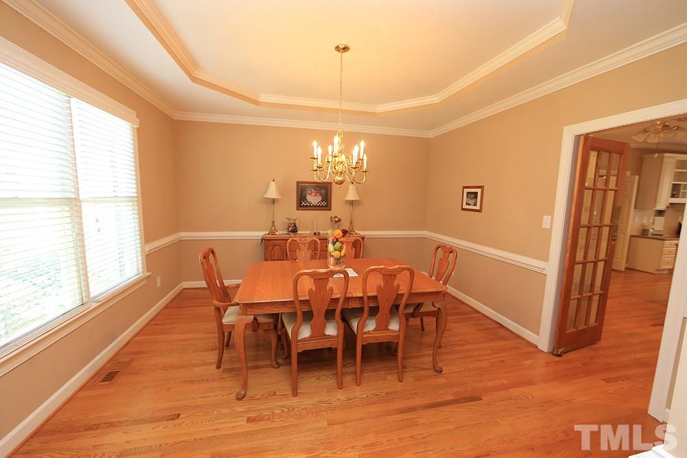 5800 Valley Mist Court Raleigh, NC 27613 - Photo 8 of 30 Trey ceiling, hardwood floor, crown molding and chair rail