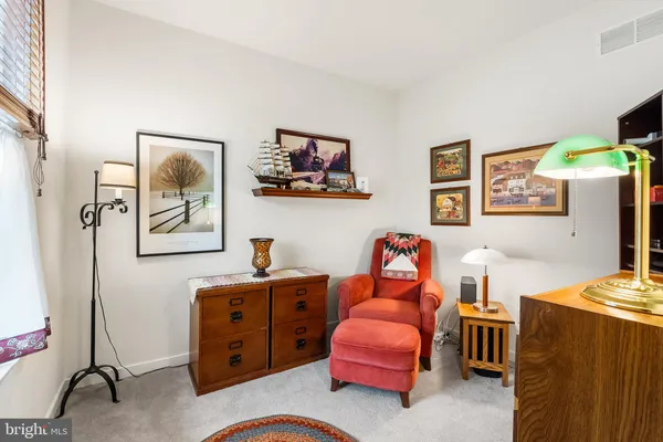 a bedroom with a bed and a workspace