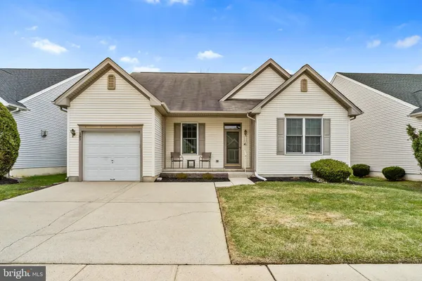 a view of house with yard and outdoor seating