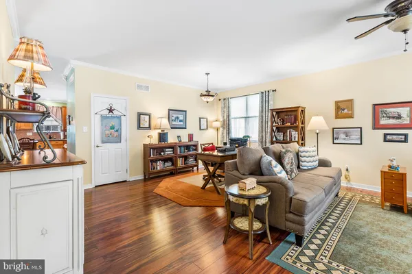 a living room with fireplace furniture and a wooden floor